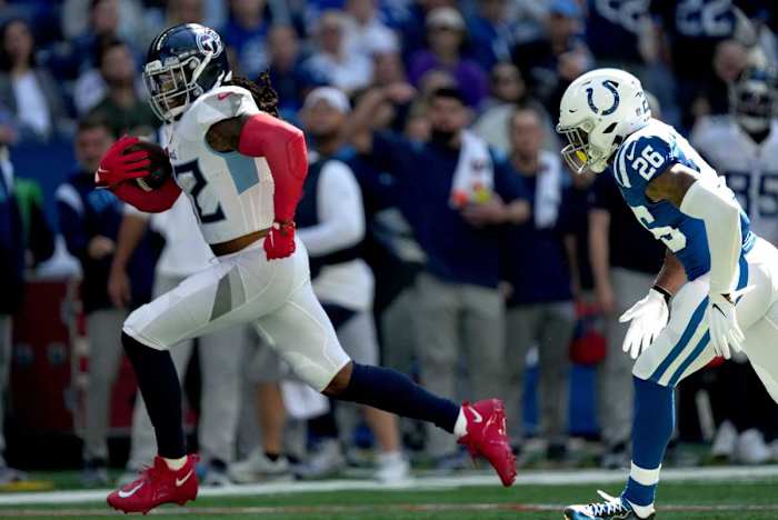 Tennessee Titans running back Derrick Henry (22) runs in a touchdown while being chased by Indianapolis Colts safety Rodney McLeod Jr. (26) on Sunday, Oct. 2, 2022, during a game against the Tennessee Titans at Lucas Oil Stadium in Indianapolis.